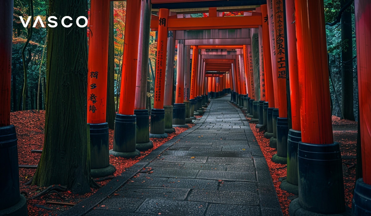 Un chemin menant à un beau Torii rouge situé dans une forêt.