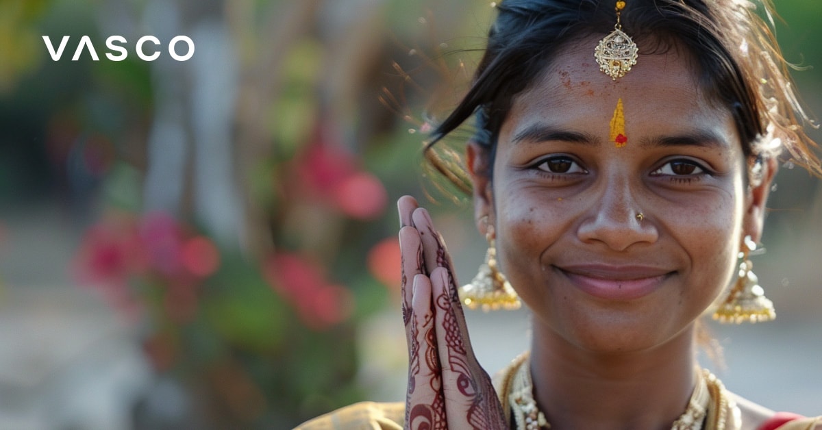 Une femme en tenue traditionnelle indienne, les mains dans un geste de salutation, illustrant la façon de dire bonjour dans plusieurs langues.